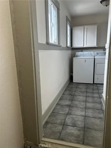 a view of a kitchen with wooden floor and a window