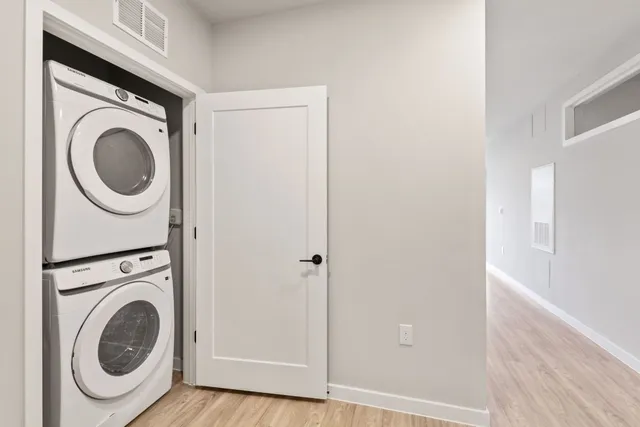 a view of a hallway with washer and dryer