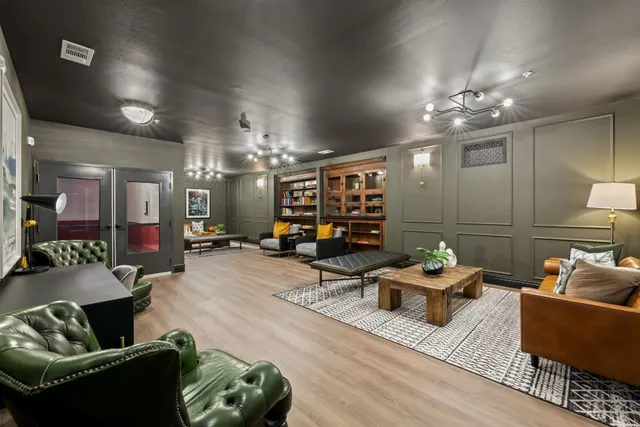 an empty room with kitchen and white cabinets