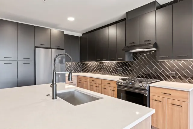 a kitchen with granite countertop a stove and a sink