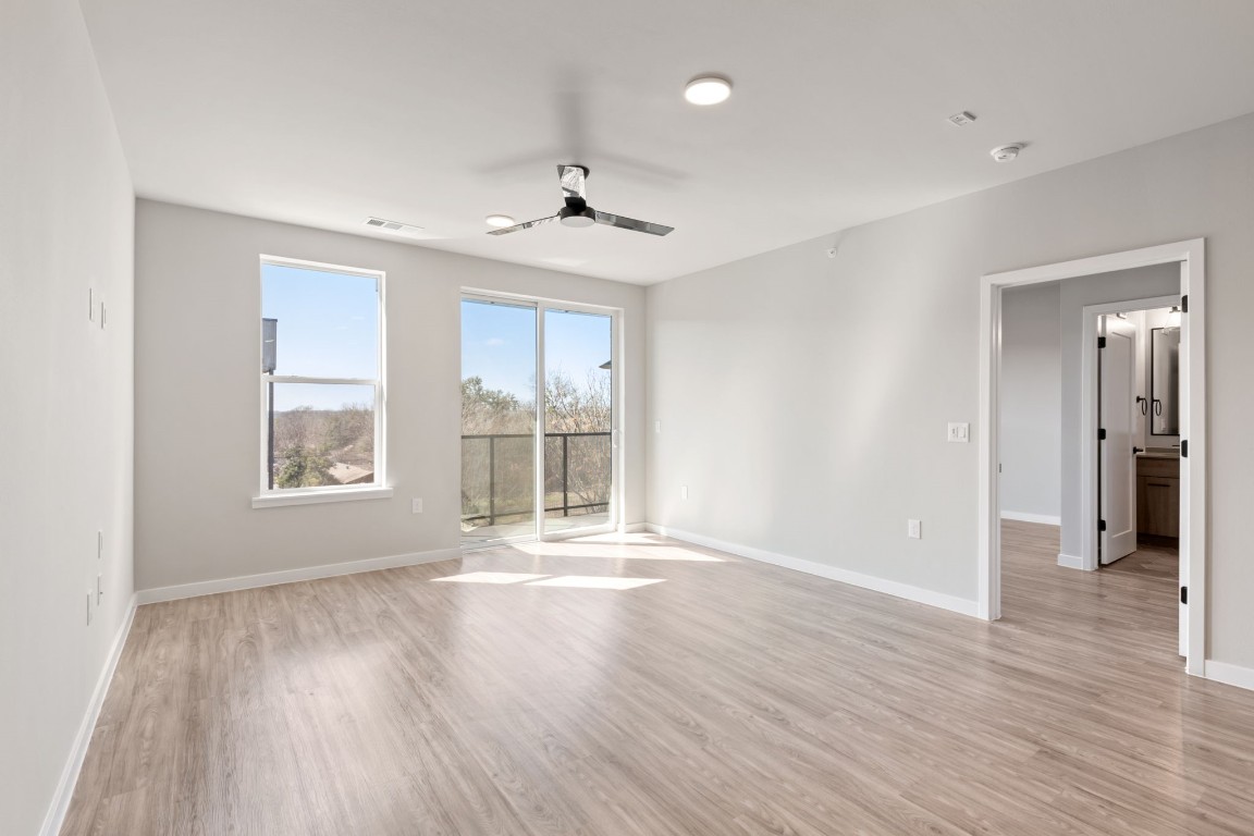 4510 Terry-O Lane, Unit 302 Austin, TX 78745 - Photo 3 of 25 a view of an empty room with wooden floor and a window