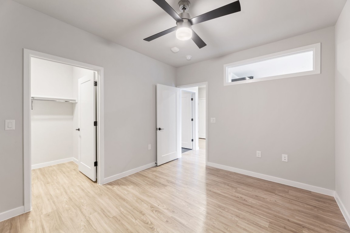 4510 Terry-O Lane, Unit 302 Austin, TX 78745 - Photo 5 of 25 an empty room with wooden floor and ceiling fan