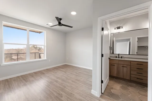 a bathroom with a granite countertop sink a mirror and a window