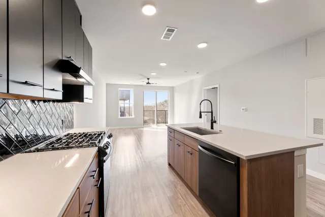 a kitchen with a sink stove and cabinets