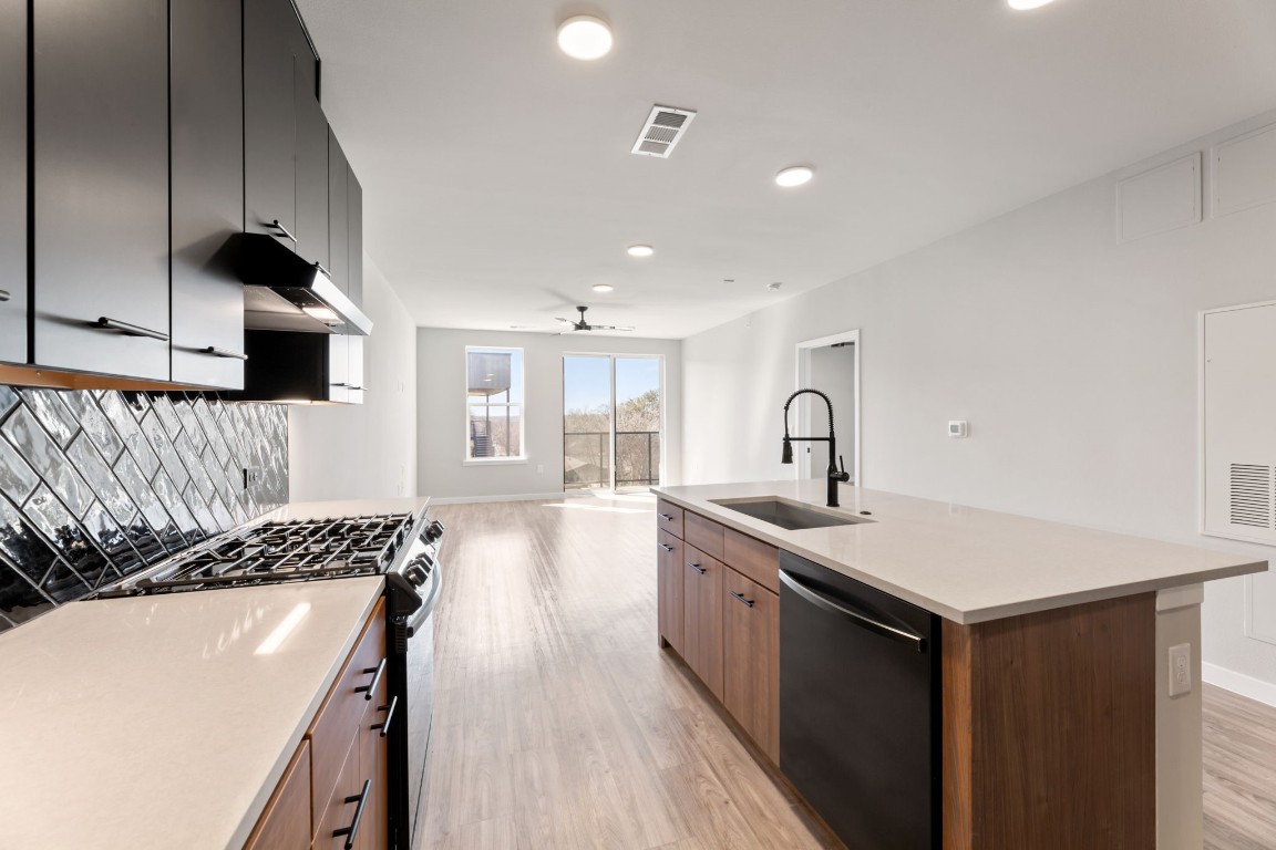4510 Terry-O Lane, Unit 302 Austin, TX 78745 - Photo 8 of 25 a kitchen with a sink stove and cabinets