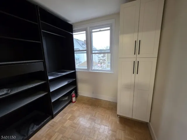 a view of closet area with empty racks