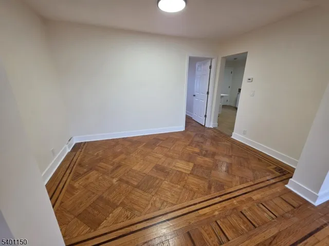 a view of a room with wooden floor
