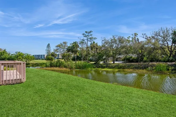a view of a lake with houses in the back