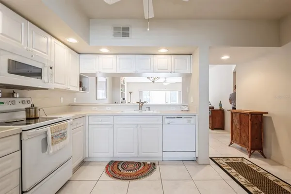 a kitchen with a sink cabinets and window
