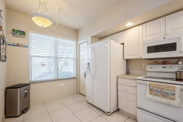 a kitchen with stainless steel appliances white cabinets and a refrigerator