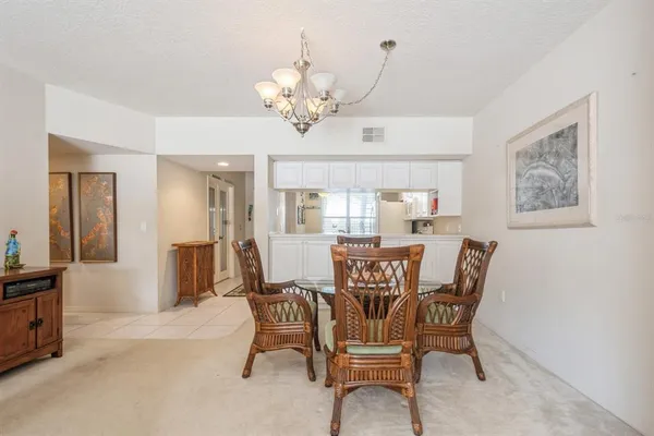 a view of a dining room with furniture and chandelier