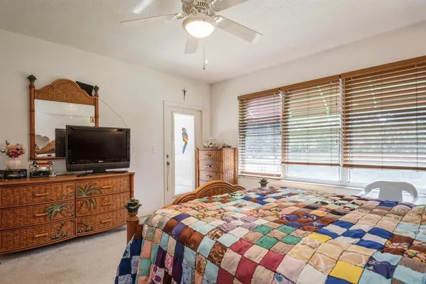 a bedroom with a bed and flat screen tv