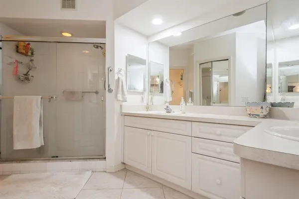 a spacious bathroom with a shower and a sink