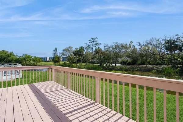 a balcony with wooden floor and fence