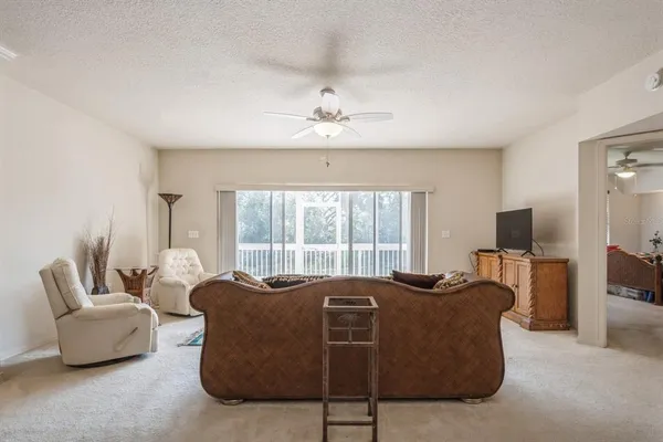 a living room with furniture window and a flat screen tv