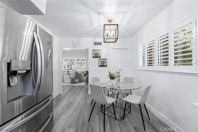 a large kitchen with stainless steel appliances lots of counter space and wooden floor