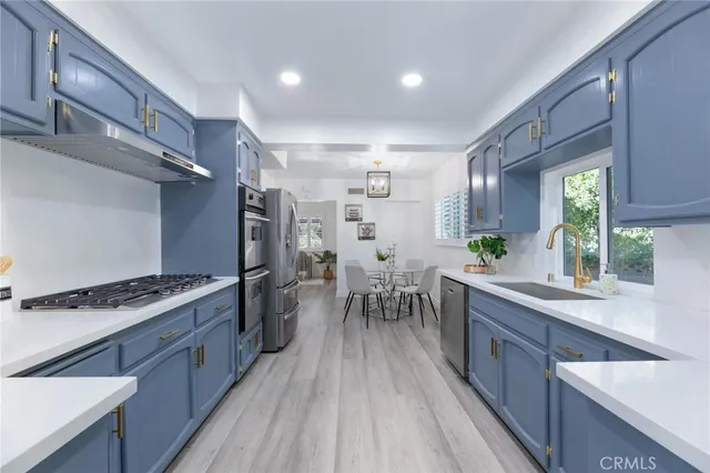 a kitchen with stainless steel appliances and wooden cabinets