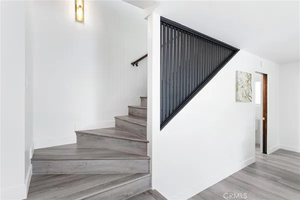 a spacious bedroom with a bed a mirror and lamp on desk