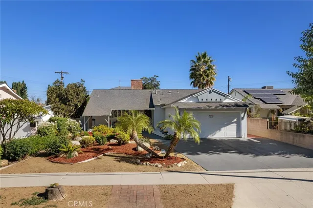 front view of a house with potted plants