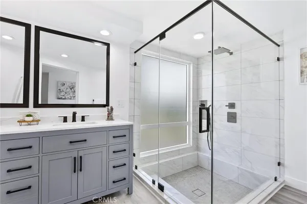 a bathroom with a glass shower door