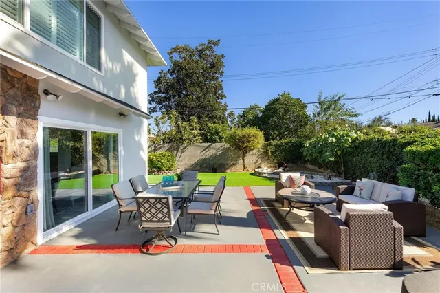 a backyard of a house with yard and outdoor seating