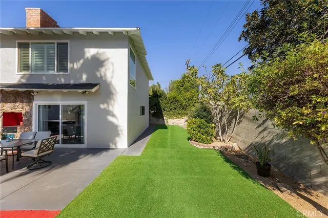 an aerial view of a house with a yard basket ball court and outdoor seating