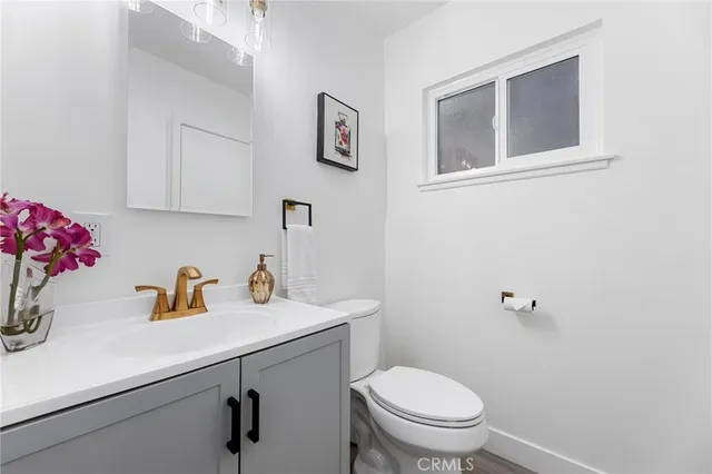 a view of a hallway with wooden floor and cabinet