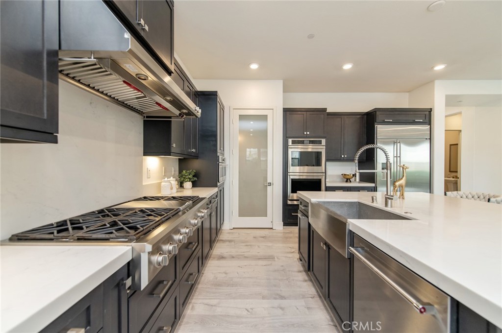 113 Measure Irvine, CA 92618 - Photo 11 of 39 a kitchen with stainless steel appliances granite countertop a sink stove and refrigerator