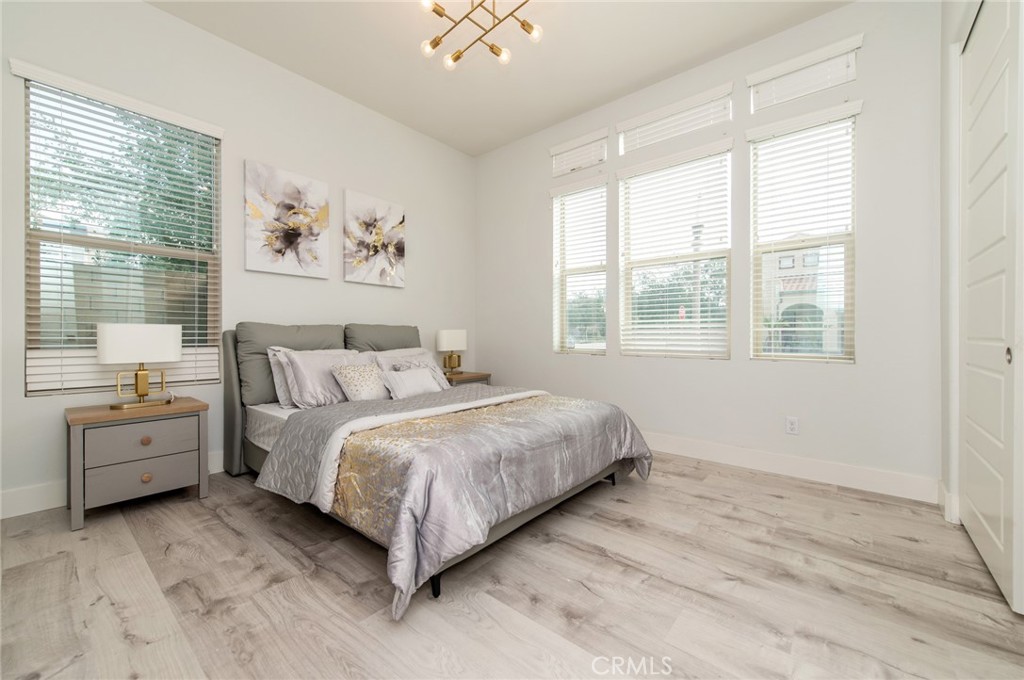113 Measure Irvine, CA 92618 - Photo 15 of 39 a spacious bedroom with a large bed and a window