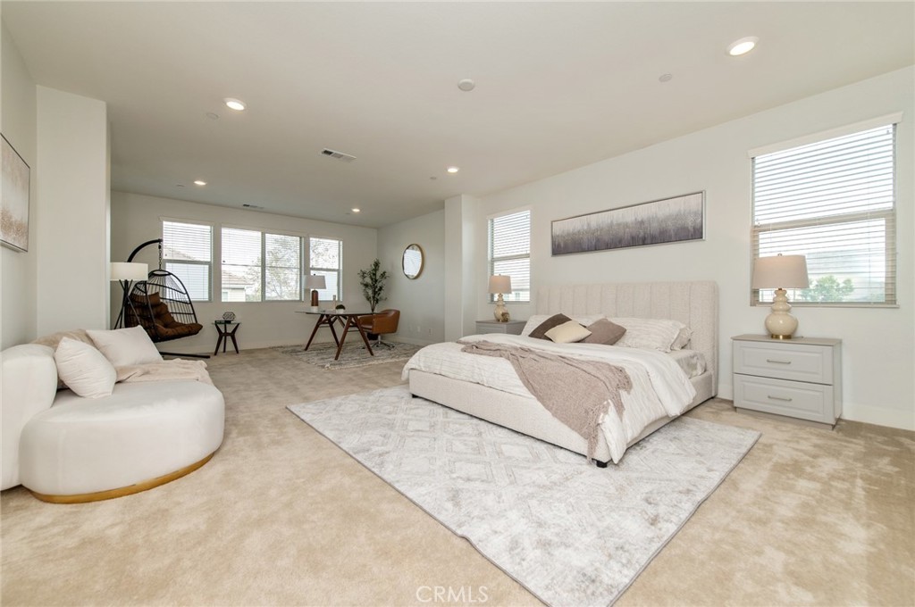 113 Measure Irvine, CA 92618 - Photo 23 of 39 a spacious bedroom with a bed a couch and large window