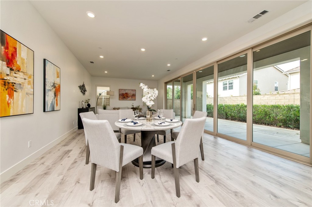 113 Measure Irvine, CA 92618 - Photo 3 of 39 a view of a dining room with furniture wooden floor and a chandelier