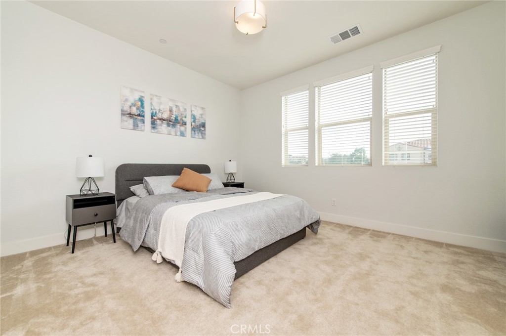 113 Measure Irvine, CA 92618 - Photo 35 of 39 a spacious bedroom with a bed and window