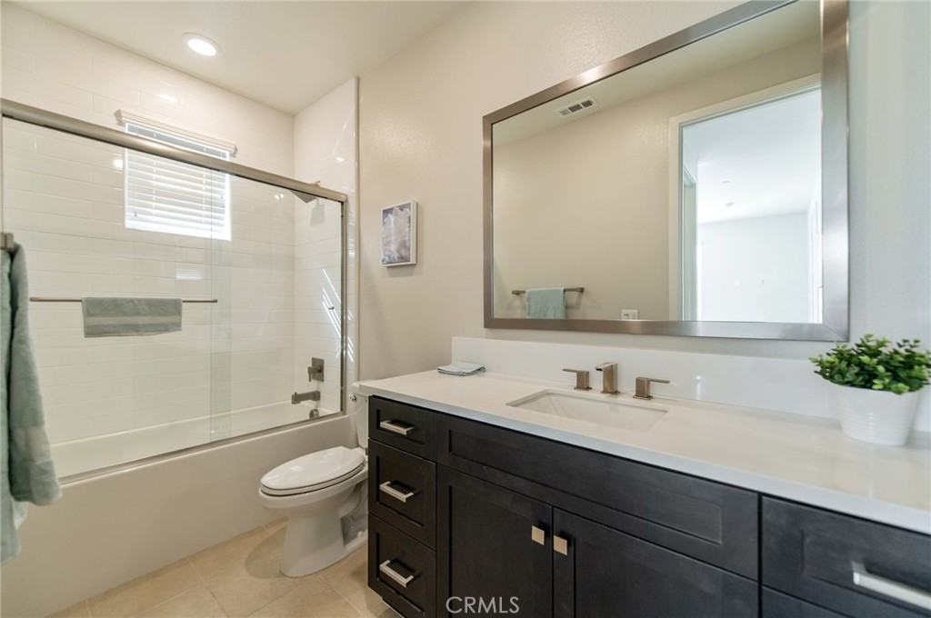 113 Measure Irvine, CA 92618 - Photo 36 of 39 a bathroom with a sink a toilet and shower