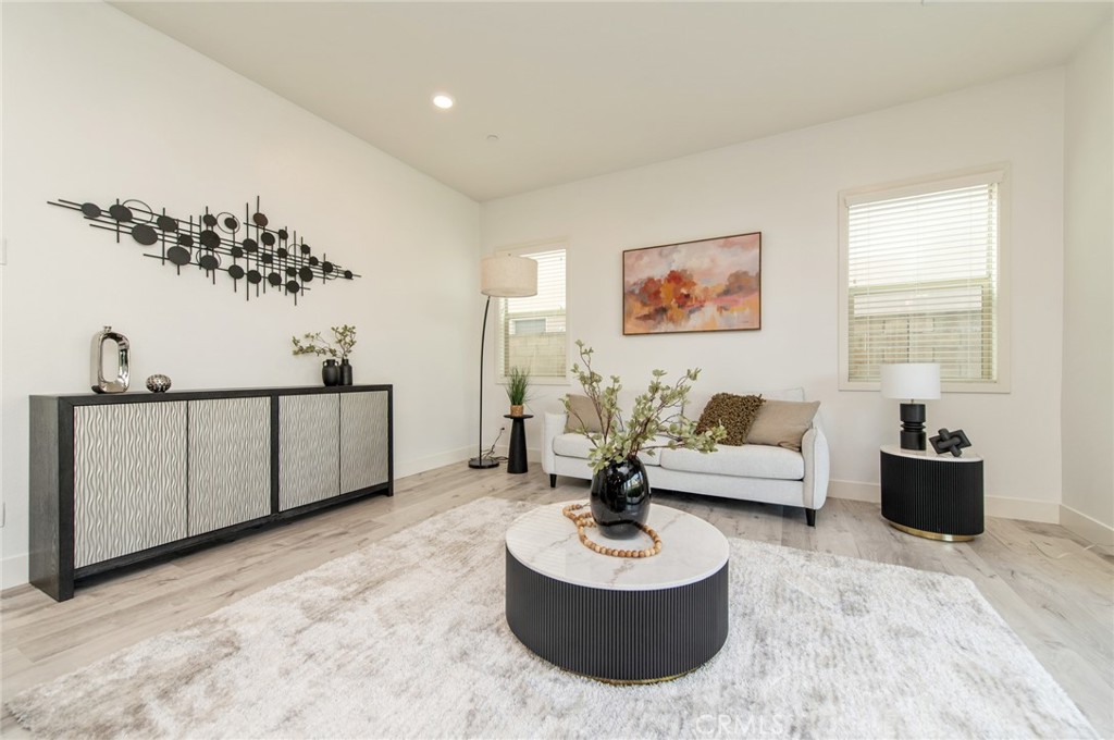 113 Measure Irvine, CA 92618 - Photo 5 of 39 a living room with furniture a couch and a potted plant