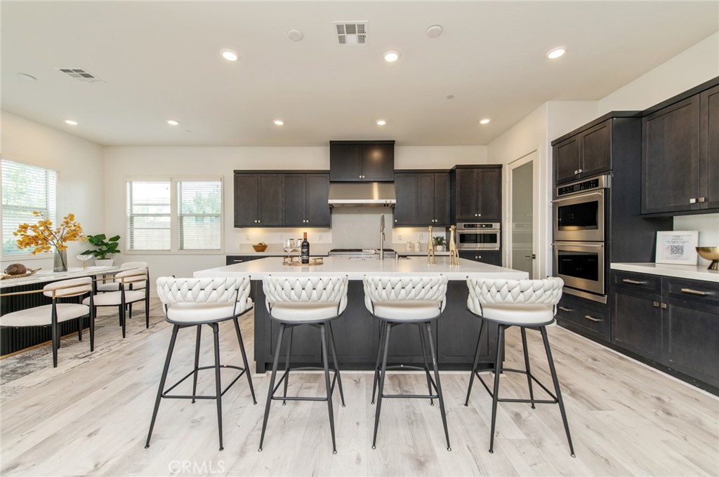 113 Measure Irvine, CA 92618 - Photo 6 of 39 a kitchen with stainless steel appliances kitchen island granite countertop a kitchen island hardwood floor sink and stove