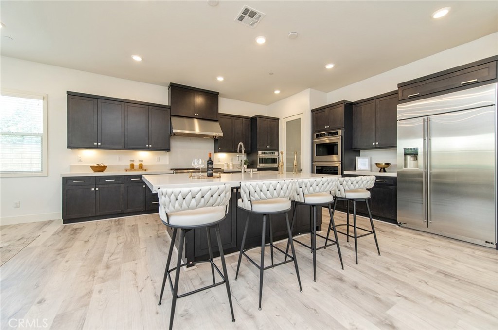 113 Measure Irvine, CA 92618 - Photo 7 of 39 a kitchen with stainless steel appliances kitchen island granite countertop a sink and cabinets
