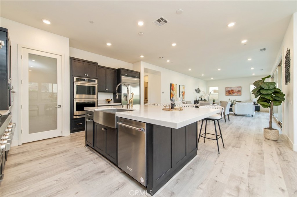 113 Measure Irvine, CA 92618 - Photo 10 of 39 a kitchen with stainless steel appliances kitchen island a sink and cabinets