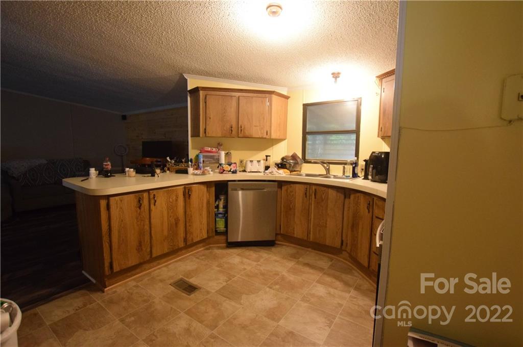 272 Lloyd Drive Mars Hill, NC 28754 - Photo 8 of 21 a kitchen with a sink a stove cabinets and a counter top space