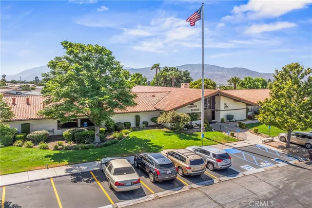 a view of a patio with table and chairs potted plants