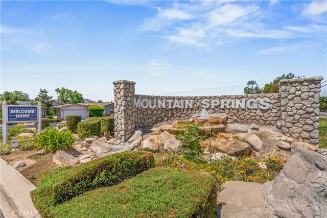 a view of a house with a yard and lake view