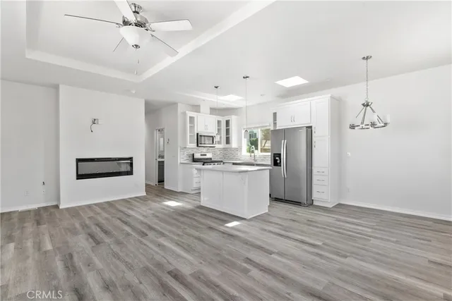 a view of kitchen with refrigerator microwave and stove