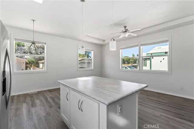 a kitchen with a wooden floor and window