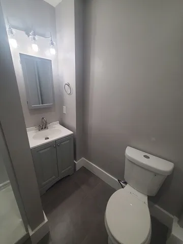 a white toilet sitting next to a bathroom sink