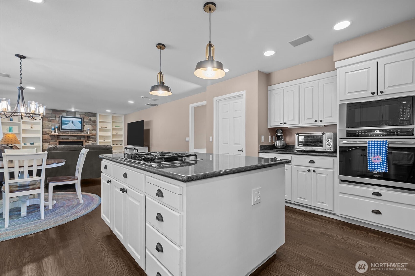 102 Stone Ridge Drive Snohomish, WA 98290 - Photo 12 of 38 a kitchen with stainless steel appliances kitchen island granite countertop a stove a sink and a refrigerator