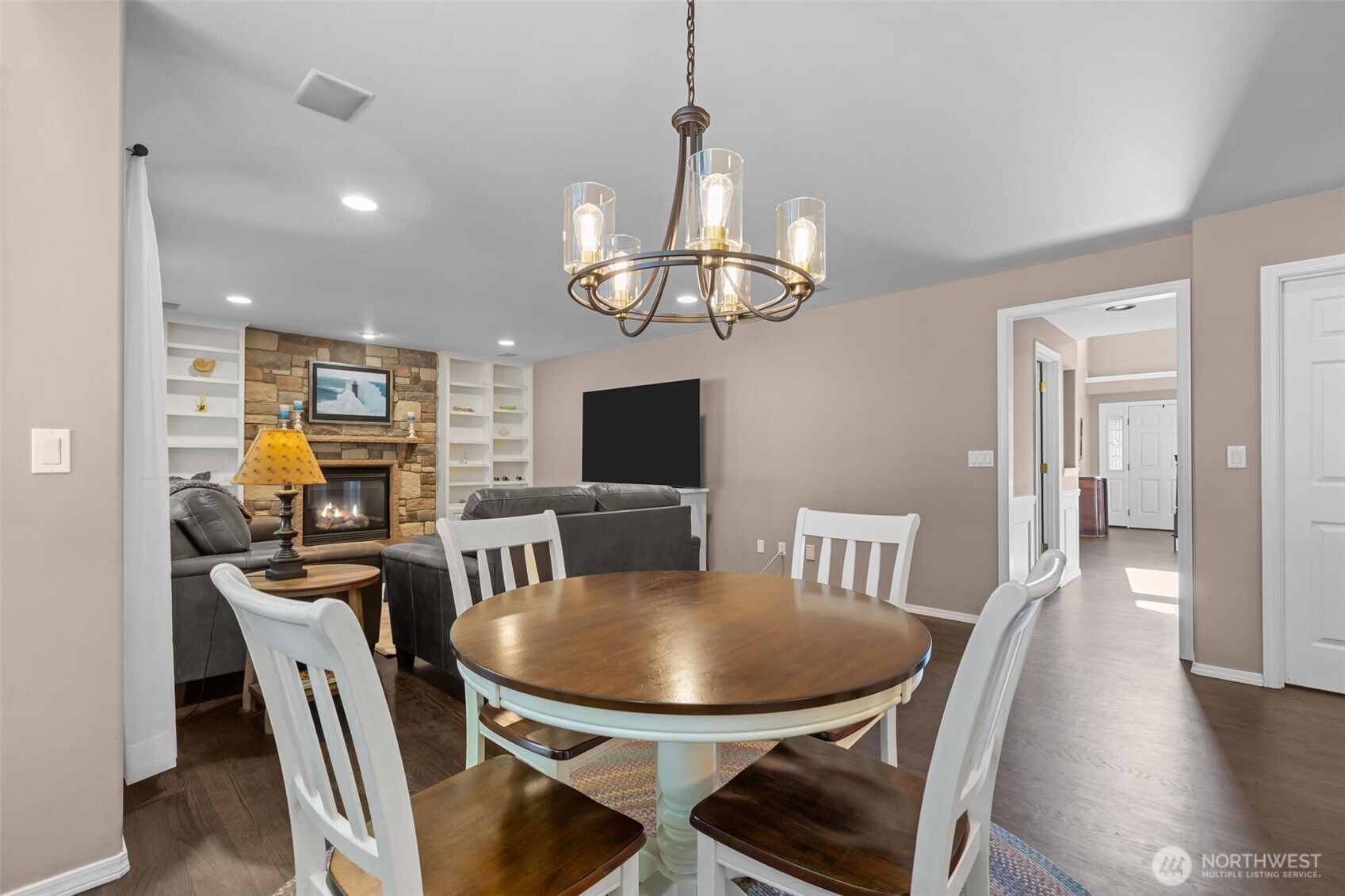 102 Stone Ridge Drive Snohomish, WA 98290 - Photo 16 of 38 a view of a dining room with furniture a chandelier and wooden floor