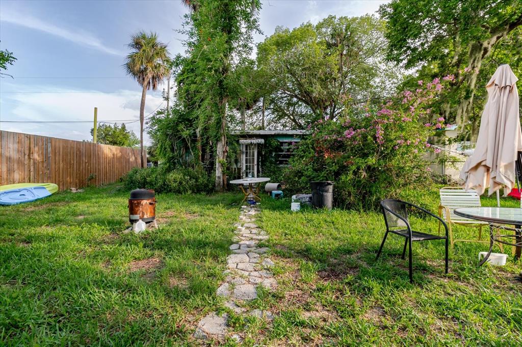 5323 Circle Drive Weeki Wachee, FL 34607 - Photo 59 of 77 a backyard of a house with table and chairs plants