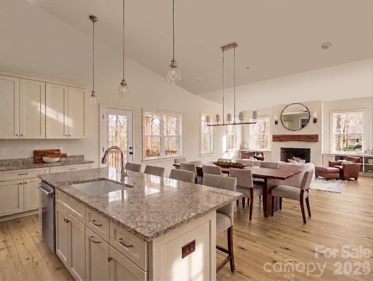 285 Woodridge Drive Rutherfordton, NC 28139 - Photo 6 of 42 a kitchen with granite countertop a stove a sink a dining table chairs and chandelier
