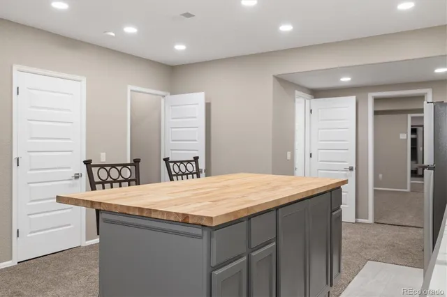 a kitchen with a sink vanity and a refrigerator