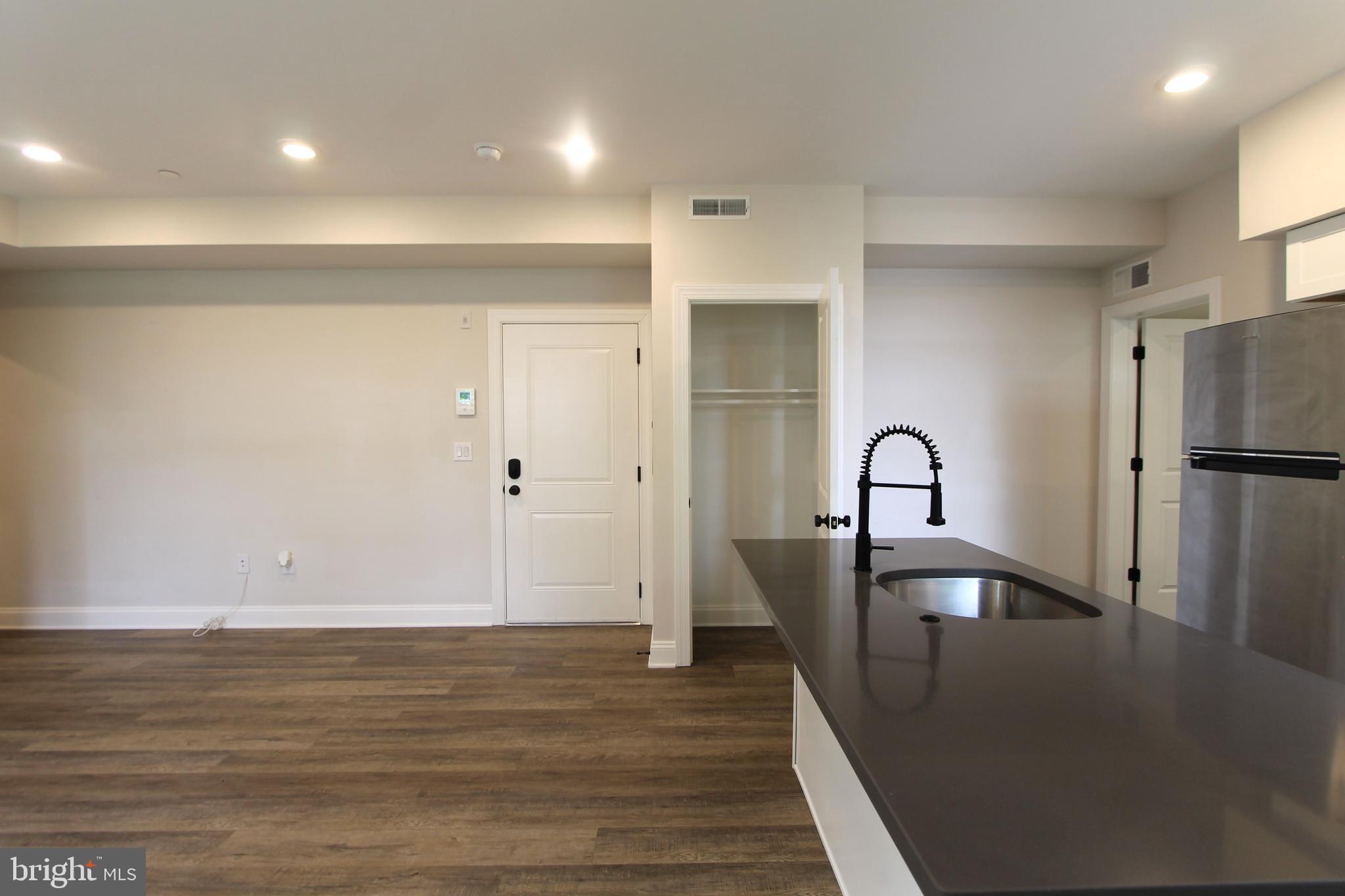 492 Roxborough Avenue, Unit 403 Philadelphia, PA 19128 - Photo 11 of 28 a view of a kitchen with a sink and refrigerator