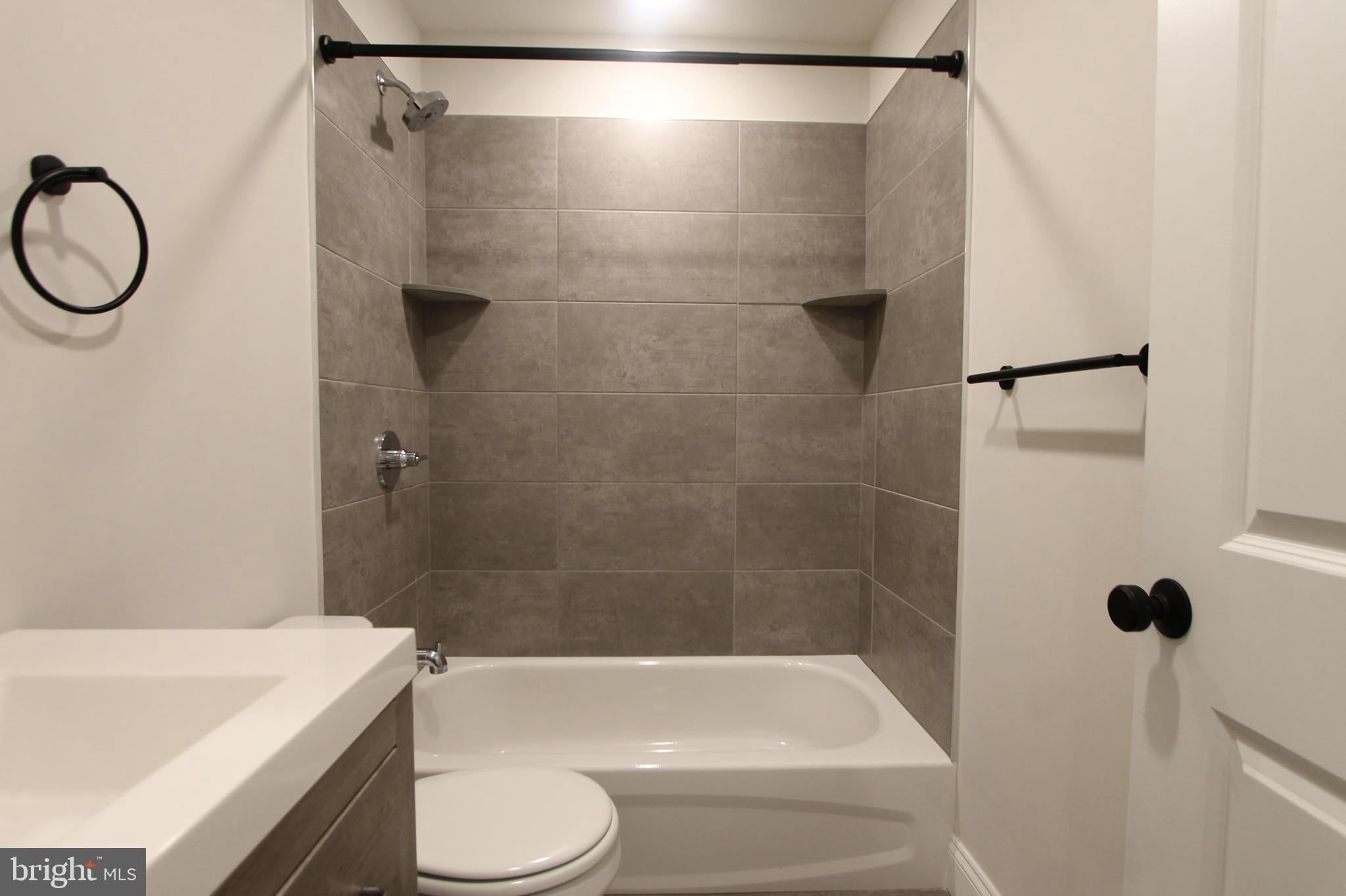 492 Roxborough Avenue, Unit 403 Philadelphia, PA 19128 - Photo 15 of 28 a bathroom with a shower a bathtub and a shower